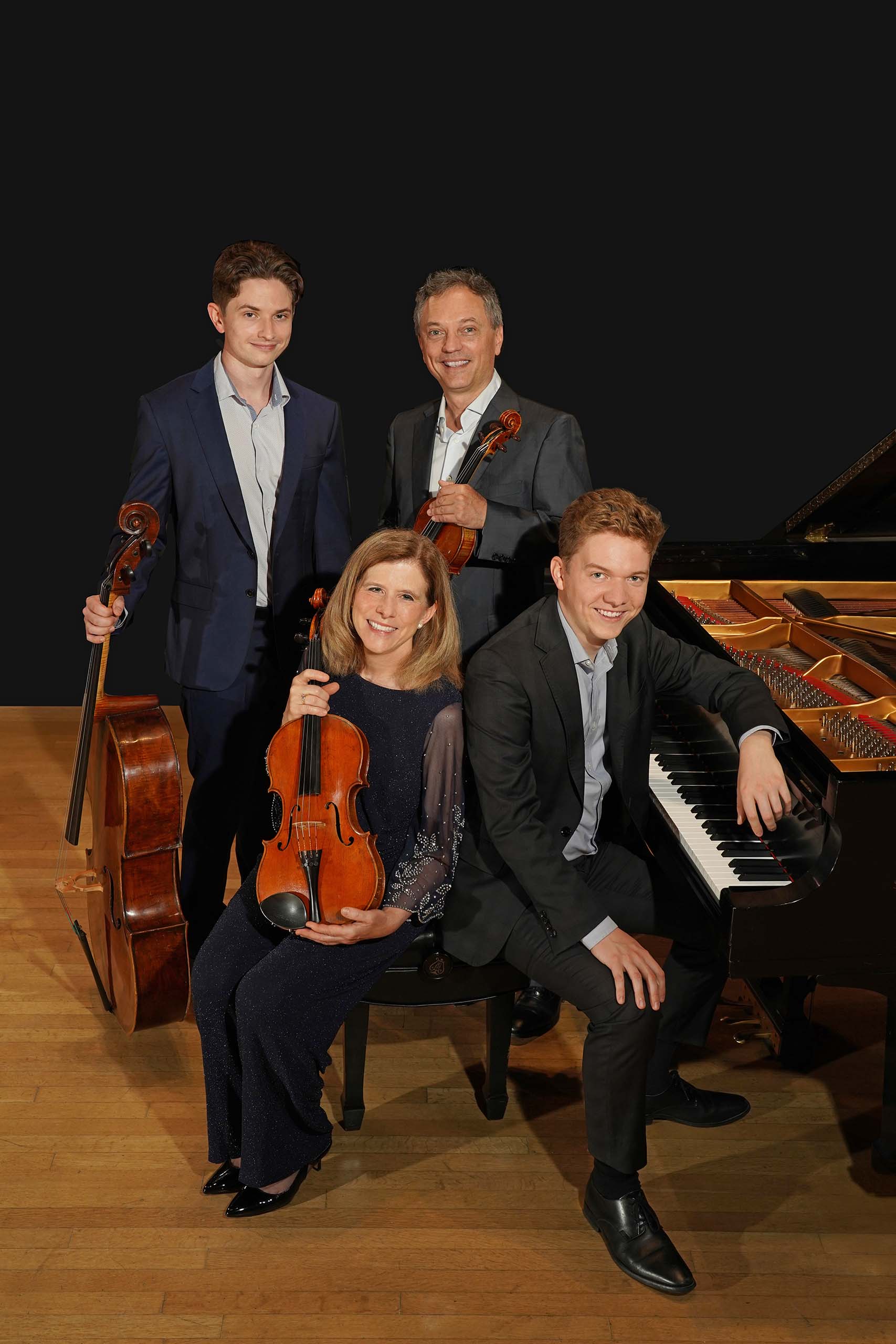 The Berofsky Quartet poses with piano and string instruments.
